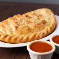Calzone · Mozzarella cheese wrapped with butter-brushed dough sprinkled with Parmesan and oregano, the...