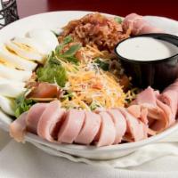 Top Chef Salad · Mixed greens topped with tomato, shredded cheddar & monterey cheese, ham, turkey, bacon crum...