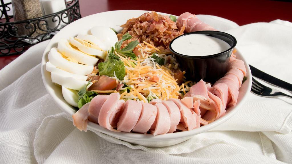 Top Chef Salad · Mixed greens topped with tomato, shredded cheddar & monterey cheese, ham, turkey, bacon crumbles and hard boiled egg.