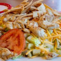 Chicken Fiesta Salad · Grilled or fried chicken strips on a bed of lettuce, cheese, tomatoes and tortilla croissant...