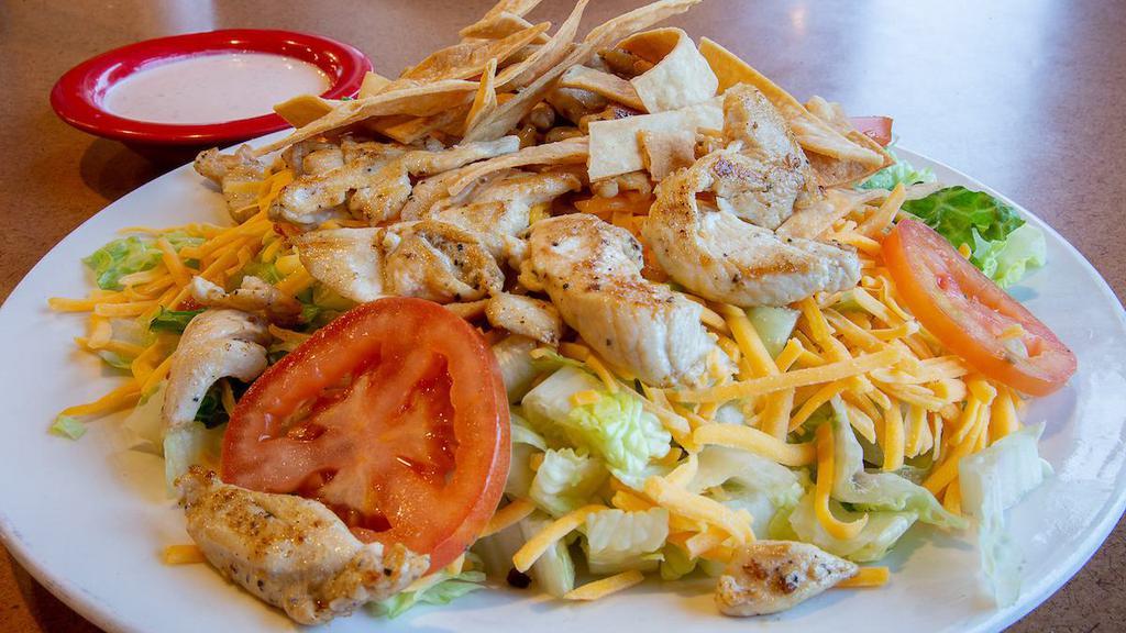 Fajita Salad · Crispy flour shell filled with your choice or grilled chicken or steak cooked with onions, bell peppers and tomatoes. Topped with cheese dip, lettuce, guacamole, sour cream and tomatoes.