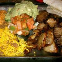 Carnitas · Lean pork marinated with oranges and spices then slowly cooked until tender, served with bea...