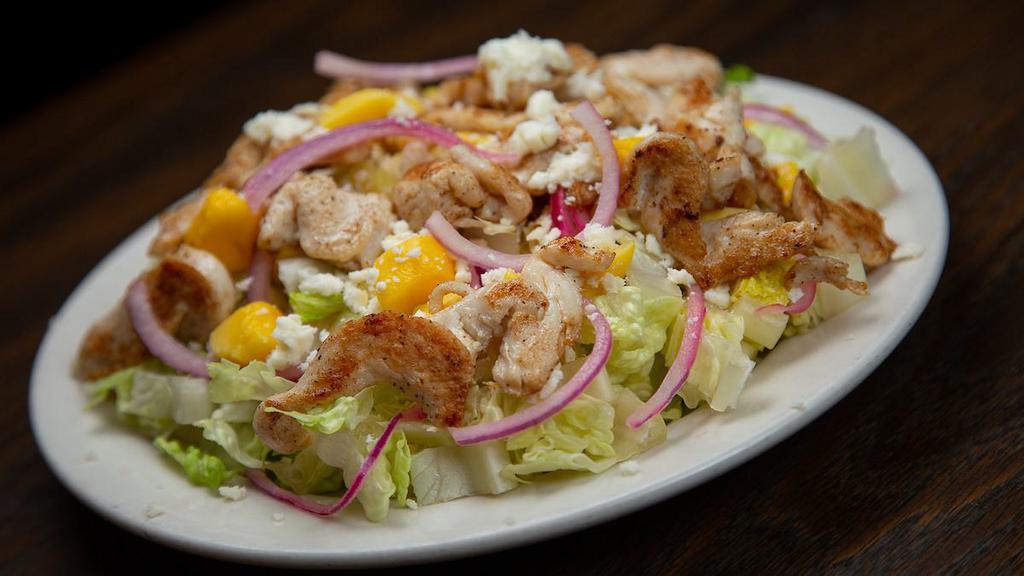 Azteca Chicken Salad · Crisp romaine lettuce drizzled with Felipe’s homemade lime vinaigrette, topped with fresh mango, queso fresco crumbles and grilled chicken breast.