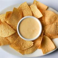 Queso Dip · Homemade queso served with tortilla chips and grilled jalapeno.