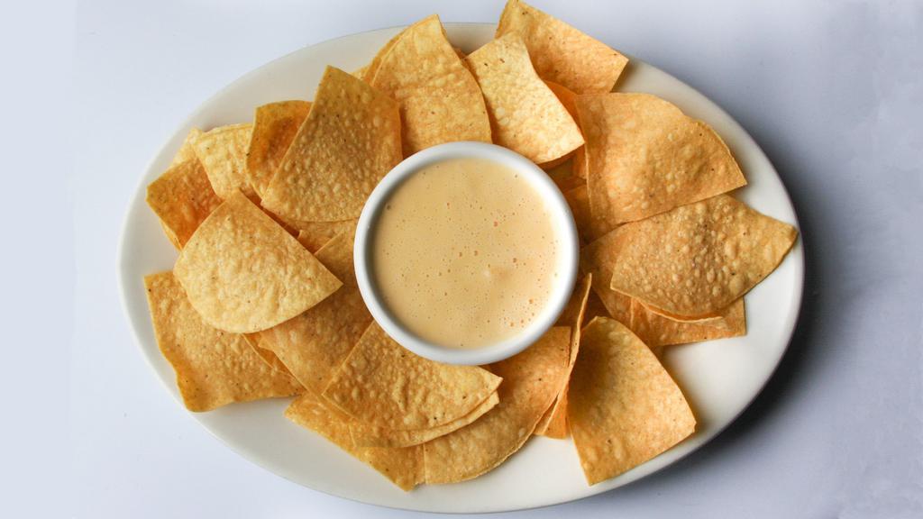 Queso Dip · Homemade queso served with tortilla chips and grilled jalapeno.