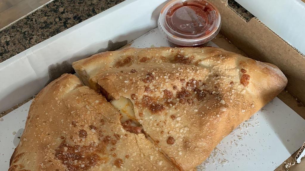 Pizza Turnover Calzone · Pizza sauce, mozzarella cheese, and pepperoni in a folded pizza dough pocket, oven baked and basted with garlic butter.