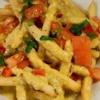Curry Fries · Crispy fries covered in sweet curry sauce and topped with red peppers, green onions and dice...