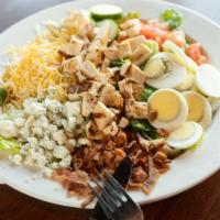 Cobb Salad · Fresh cut romaine lettuce topped with grilled chicken, blue cheese, smoked bacon, cucumbers,...