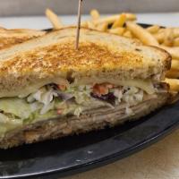 Grilled Turkey Reuben · Deli thin smoked turkey breast, creamy coleslaw, and Swiss cheese piled high on grilled rye ...