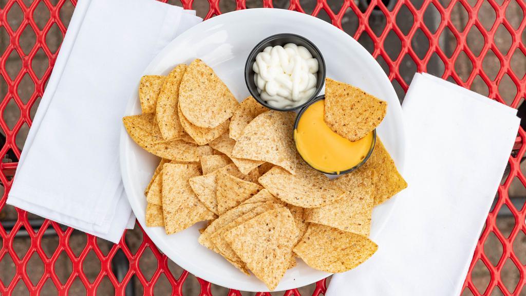 Nacho Chips · Crunchy tortilla chips, warm nacho cheese, and jalapeños.