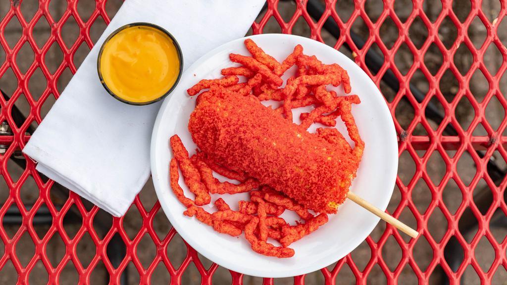 Cheeto Corn · Mouth watering, warm, buttery elote corn covered with cheeto dust and ready to eat.