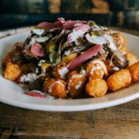 Goodwood Totchos · Louisville Lager beer cheese, peppers, onions, pickled jalapeño, pickled onions, topped with...