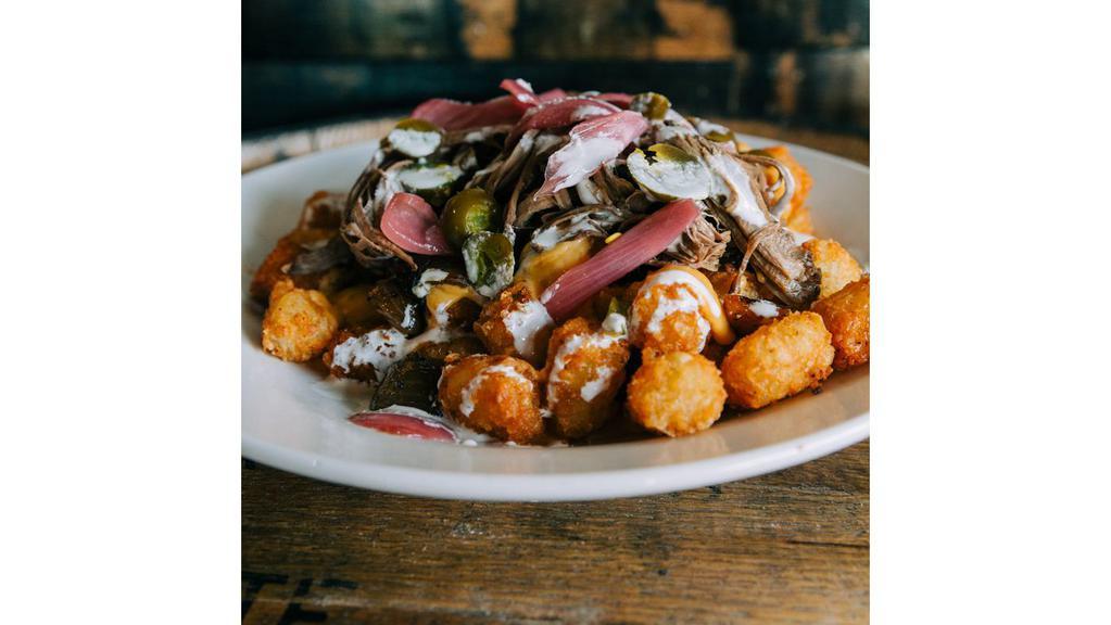 Goodwood Totchos · Louisville Lager beer cheese, peppers, onions, pickled jalapeño, pickled onions, topped with crema. Choose brisket or pork.
