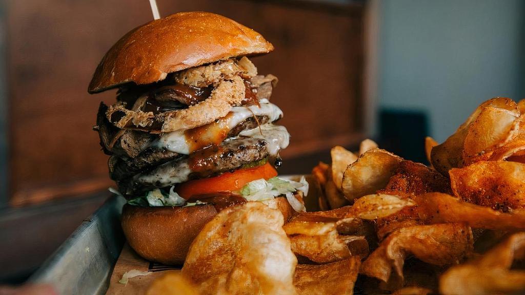 Waylon Burger · beer braised brisket topped burger, Goodwood BBQ sauce, crispy . onions, swiss cheese served on brioche bun with lettuce, tomato, onion and pickle. Includes choice of one side.