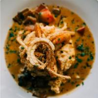Shrimp And Grits · Weisenberger cheese grits, peppers and onions, creole cream sauce, crispy onions