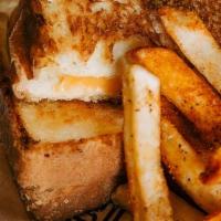 Kids Grilled Cheese · Texas toast with American cheese. Served with one side.