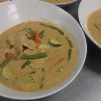 Red Curry · Served with meat stewed in our delicious red coconut milk curry garnished with eggplants, gr...