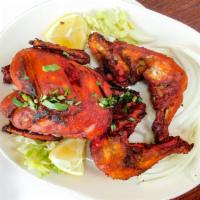 Chicken Charga · Whole chicken marinated with spices fried.