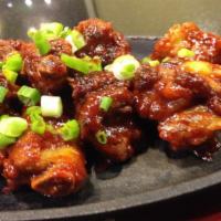 Spicy Don Galbi · Marinated pork rib braised and then grilled with a spicy chili sauce. Served with a bowl of ...