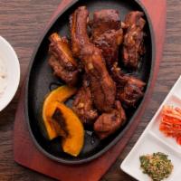 Don Galbi · Marinated pork rib braised and then grilled in sweet soy sauce. Served with a bowl of rice a...