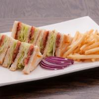 L.T. Club · Triple Decker with bacon, lettuce, tomato on toasted white bread. Served with French fries.