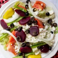 Greek Salad · Lettuce, tomatoes, green peppers, onions, feta, black olives, pepperoncini and beets.