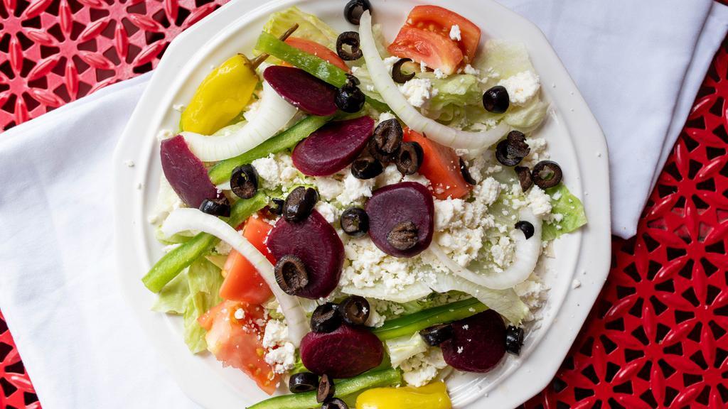 Greek Salad · Lettuce, tomatoes, green peppers, onions, feta, black olives, pepperoncini and beets.