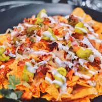Special Nachos · Topped with ground beef, lettuce, tomato, sour cream, and guacamole.