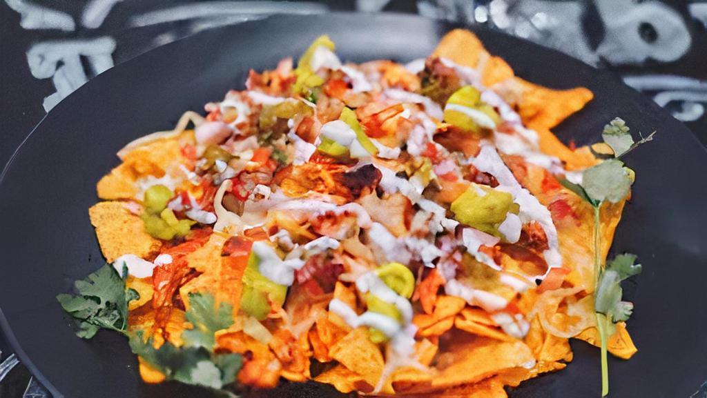 Special Nachos · Topped with ground beef, lettuce, tomato, sour cream, and guacamole.
