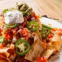 *Grilled Steak Nachos · *Notice: Foods cooked to order, consuming raw or undercooked meats, poultry, seafood, shellf...