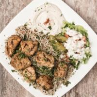 Chicken Kebab Cubes · Marinated chicken breast served on top of rice and salad, hummus or baba ghanouj
