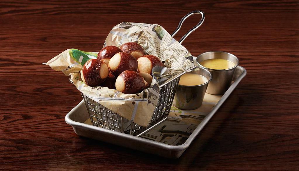 Pretzel Bites · mini pretzel bites sprinkled with Parmesan cheese & served with housemade Boston beer cheese sauce & honey mustard