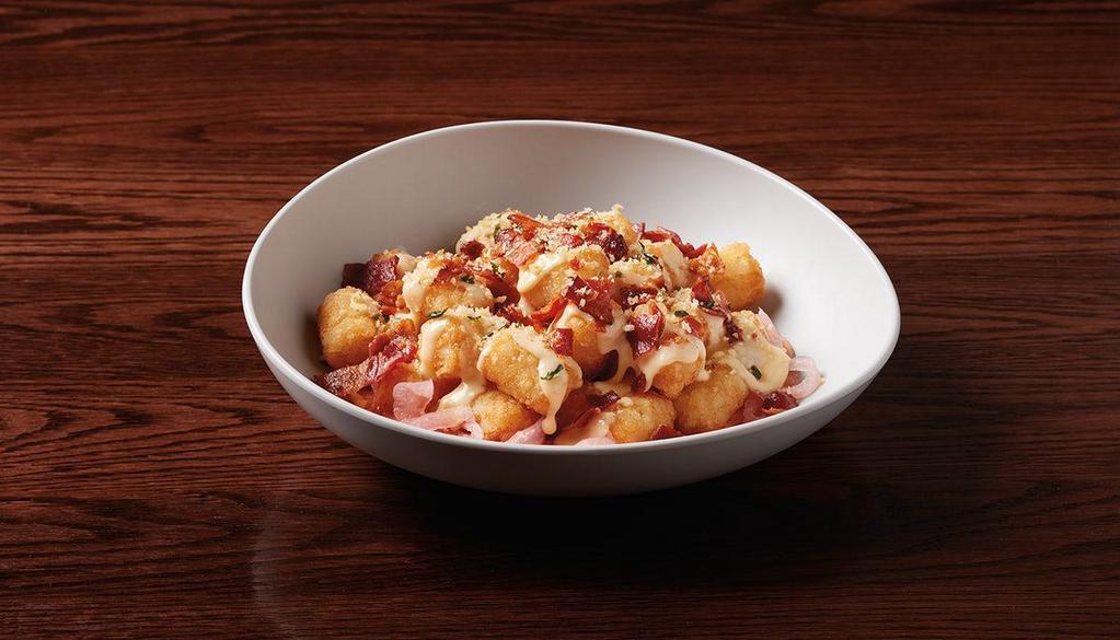 Cheese & Bacon Tots · crispy tots, Paul’s signature wahl sauce, pickled red onions, bacon, signature cheese sauce & Parmesan cheese