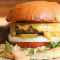 The Our Burger · 1/4 lb. burger, lettuce, tomato, onion, government cheese, Paul’s signature wahl sauce & pic...