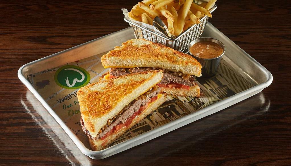 The Big Cheese · two 1/3 lb. burger patties topped with government cheese, Swiss cheese, white cheddar cheese, caramelized onions & tomatoes served between thick-cut bread & grilled with Asiago cheese