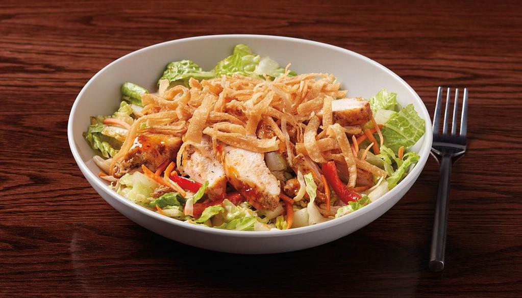 Asian Chicken Salad · Asian-glazed seared chicken, romaine, shredded cabbage, red peppers & carrots topped with wonton strips served with Asian dressing