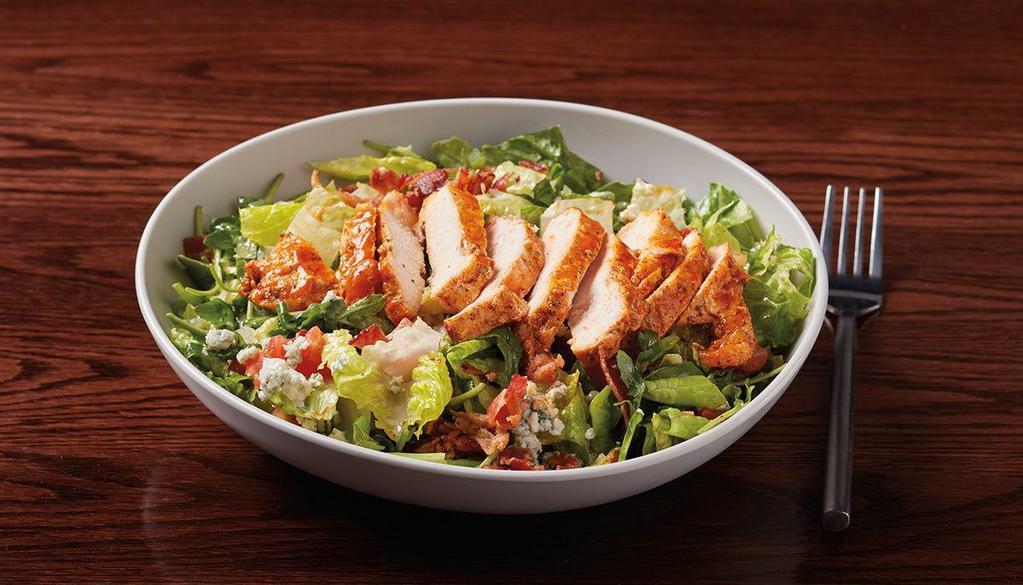 Buffalo Blue Salad · buffalo-marinated seared chicken, mixed greens, tomatoes, crumbled blue cheese & bacon bits served with housemade blue cheese vinaigrette
