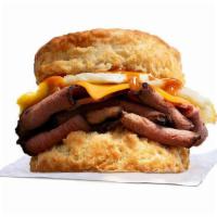 Primal Biscuit · Slow cooked sliced prime rib, with smoked cheddar, fried egg, topped with sweet n savory Amb...