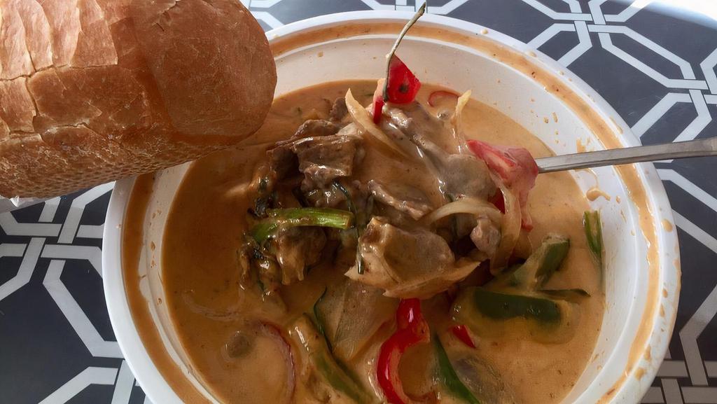 Creamy Coconut Curry · Gluten free. A flavorful coconut milk based mild red curry. Full of Thai spices, bell peppers, white onions, and green onions. Choice of protein: chicken, beef, tofu