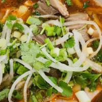 Spicy Noodle Soup “Bun Bo Hue” · Gluten free. A medium spicy lemongrass noodle soup. Comes with thick vermicelli rice noodles...