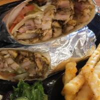 Chicken Shawarma Pita · Chicken shawarma with lettuce, tomatoes, cucumber, onions, and your choice of sauce wrapped ...
