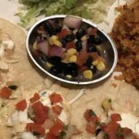 Shrimp Tacos · Grilled shrimp, cabbage instead of lettuce, pico de gallo, chipotle aioli, and cilantro crema.
