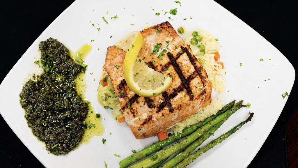 Blackened Grilled Salmon · Grilled wild alaskan salmon served with grilled asparagus, rice pilaf, and pesto sauce.