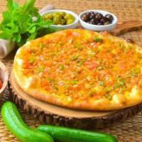 Round Veggie · Lebanese round flatbread topped with tomatoes, onions, and green bell peppers