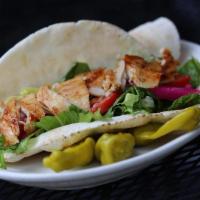 Chicken Shawarma · Chicken shawarma marinated in a special blend of spices wrapped with pickles, turnips, tomat...