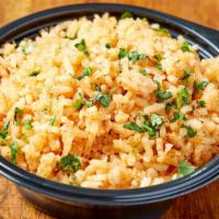 Rice · Traditional Mexican rice made with tomato, onion, cilantro, and cumin.