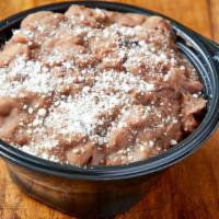 Beans · Side of housemade refried pinto beans.
