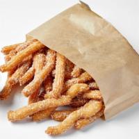 Churro Fries · Bite sized churros coated with cinnamon and sugar, served with dulce de leche caramel dippin...
