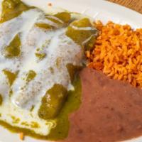 Enchiladas Suizas · Three corn enchiladas on our special green sauce and cheese sauce stuffed with chicken.