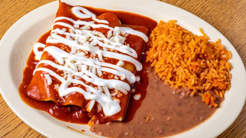 Enchiladas Mexicanas · Three corn enchiladas on red sauce stuffed with ground beef chicken or cheese topped with mozzarella cheese and sour cream.
